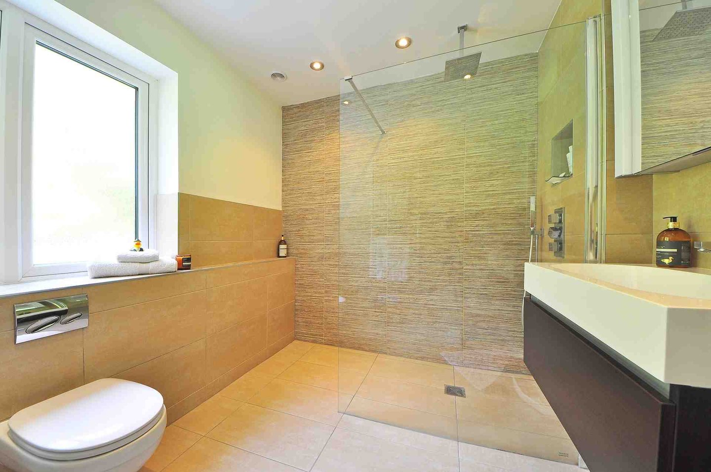 Upscale Bathroom Addition With Frameless Glass Enclosure For Walk-In Shower. 