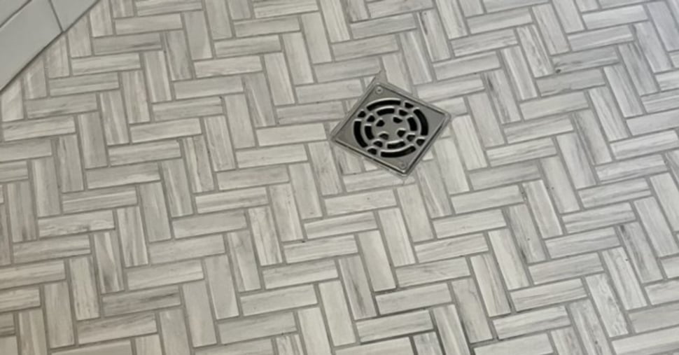 Chevron tile pattern on walk-in shower floor in Seacoast bathroom remodel