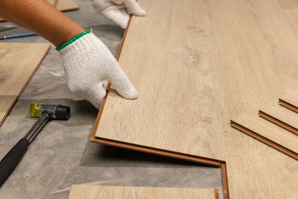 Close-up of vinyl plank flooring installation by Oxland Builders