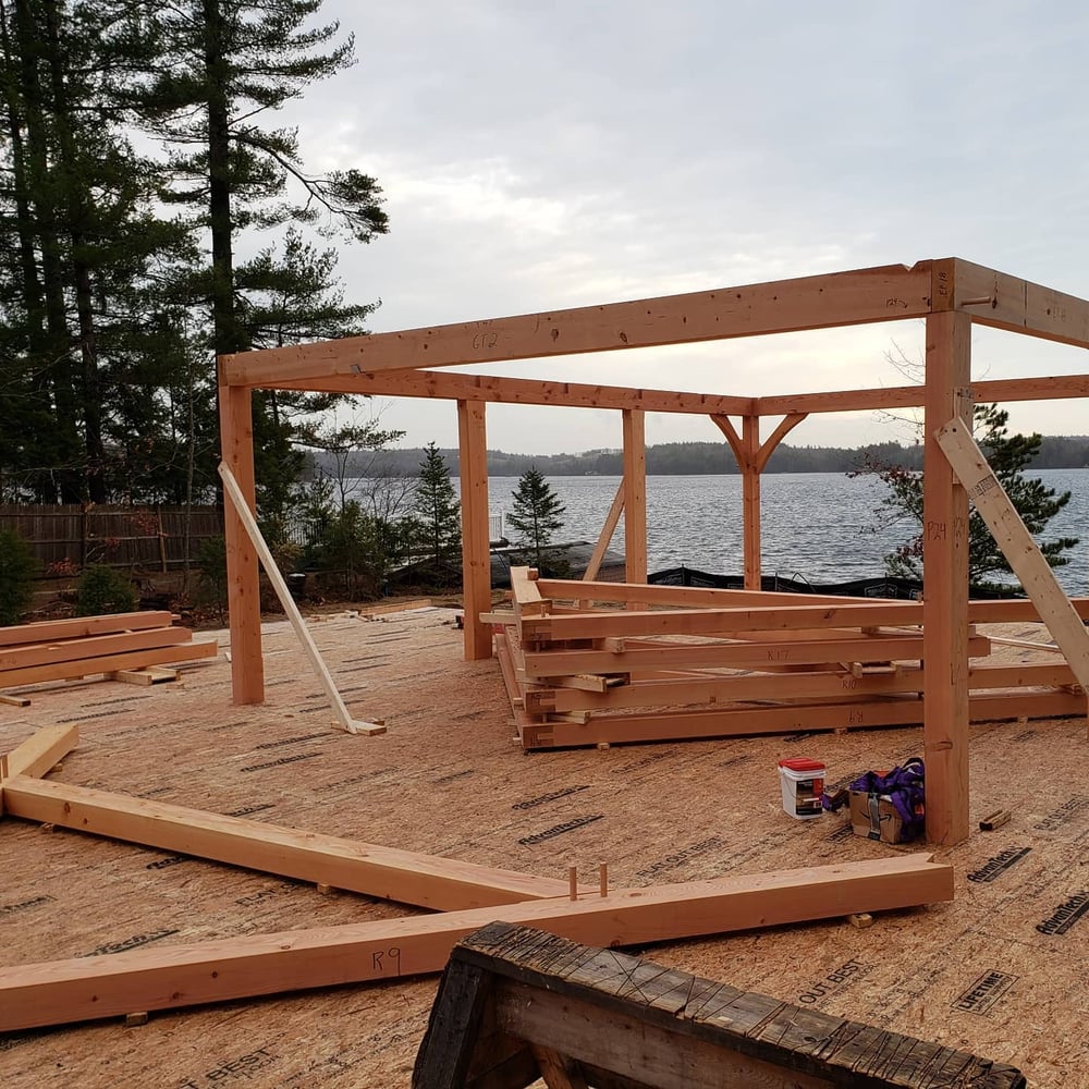 Construction progress of New Hampshire custom home on cloudy day