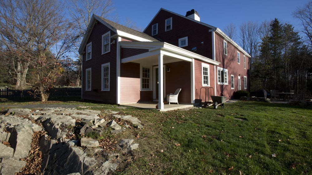 Custom home exterior with attached covered patio in Rockingham County, NH
