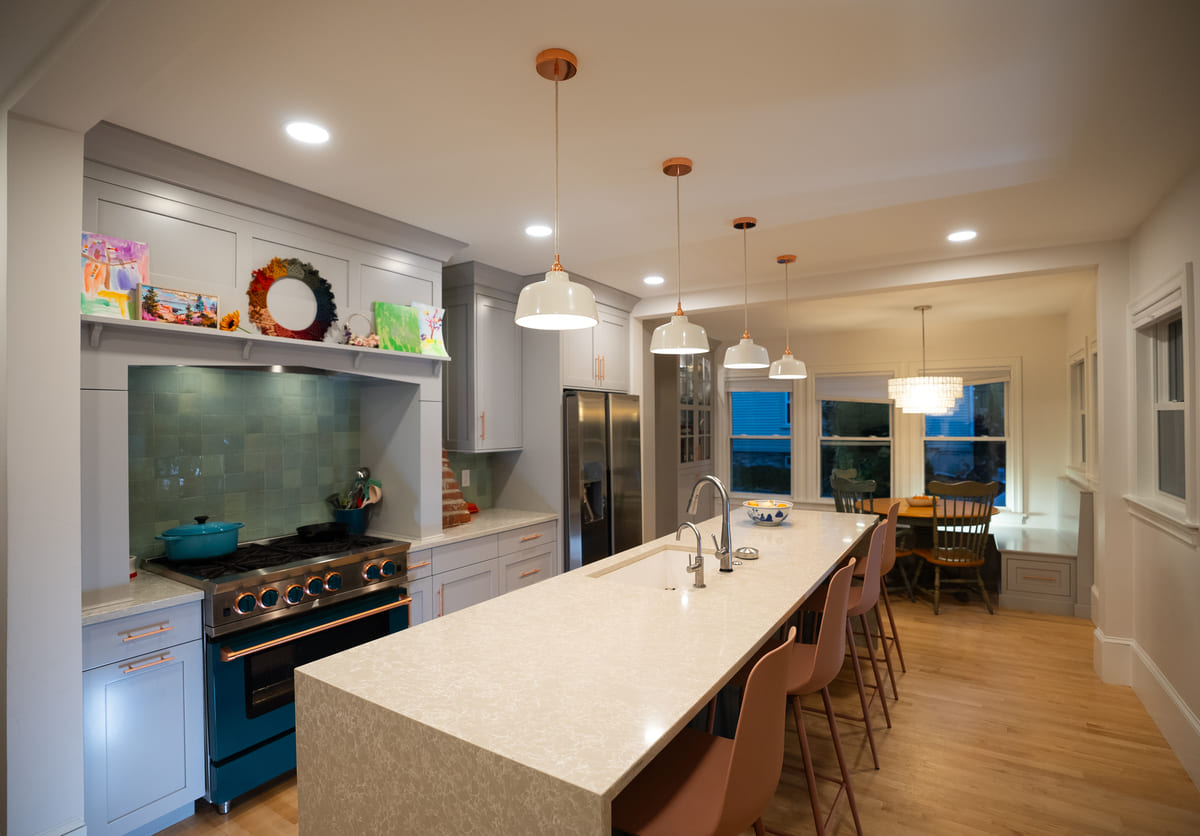 Four pendant light fixtures above island with seating in Portsmouth, NH whole home remodel