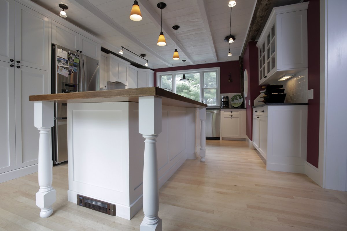 Laminate Flooring in Galley-Shaped Kitchen With Island in the Middle