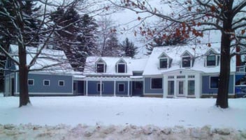 custom home in winter with snow in new hampshire