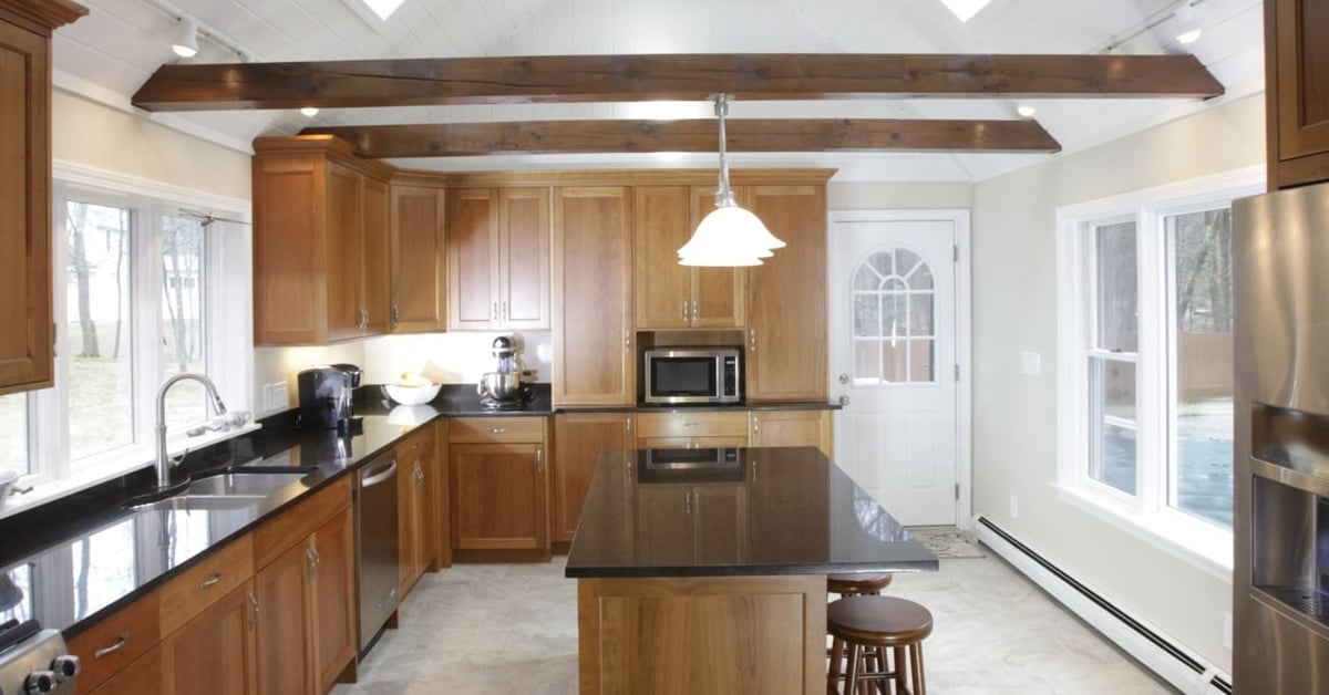Large kitchen remodel in New Hampshire with custom cabinetry and vaulted ceiling with skylights