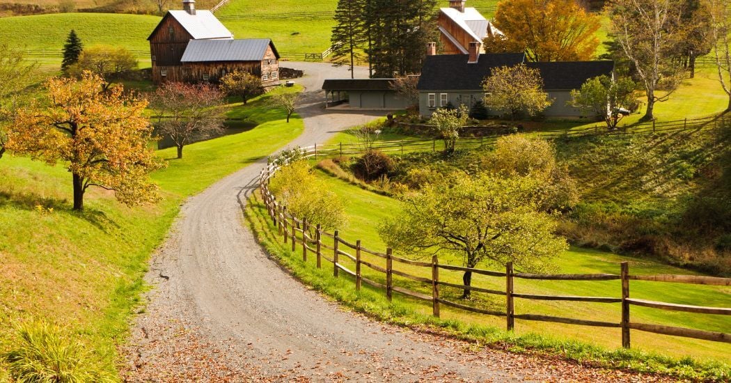 New England Homestead with Multiple Outbuildings in the fall
