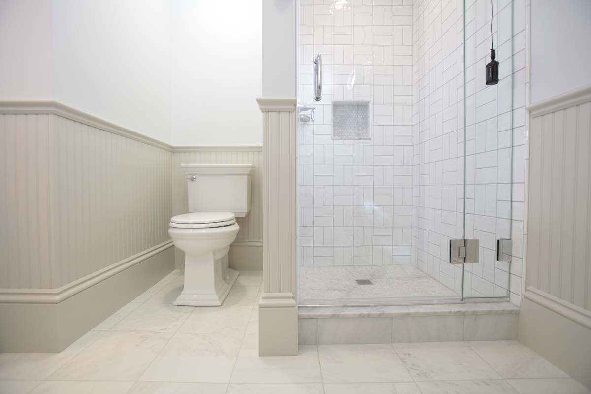 New Hampshire bathroom remodel by Oxland Builders with white mosaic tiling