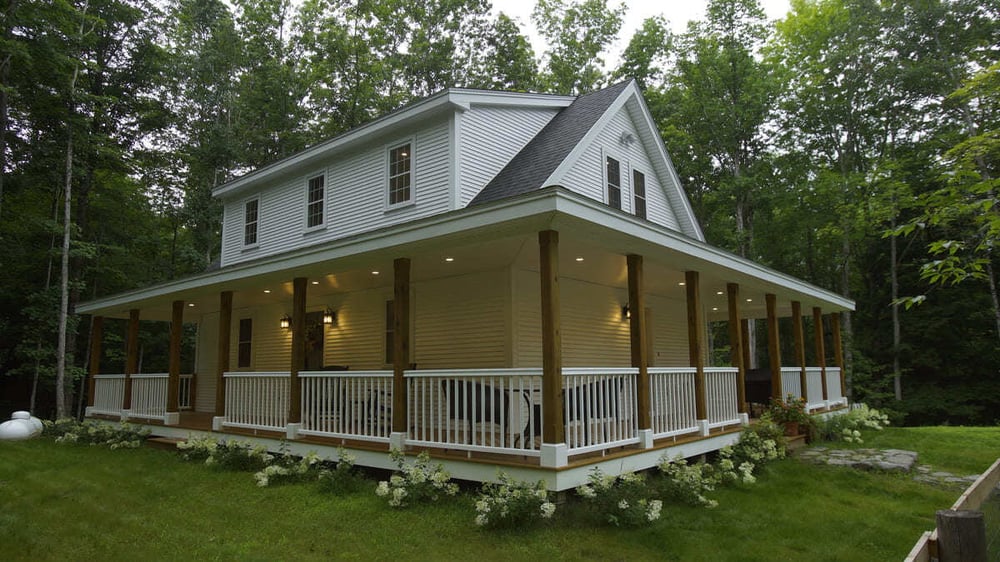 New Hampshire home exterior with wrap-around porch by Oxland Builders