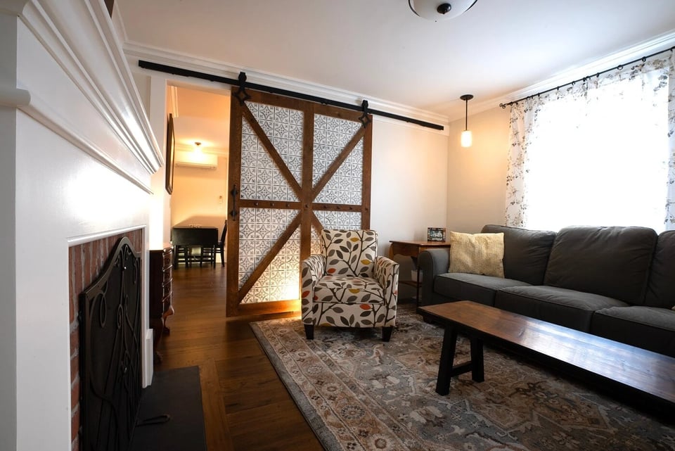 New Hampshire living room remodel with sliding door to kitchen by Oxland Builders