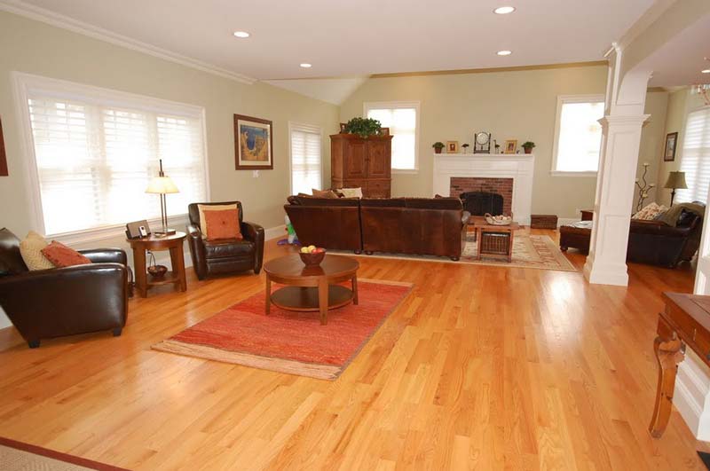 Seacoast, NH open-concept living room with recessed lighting and hardwood flooring