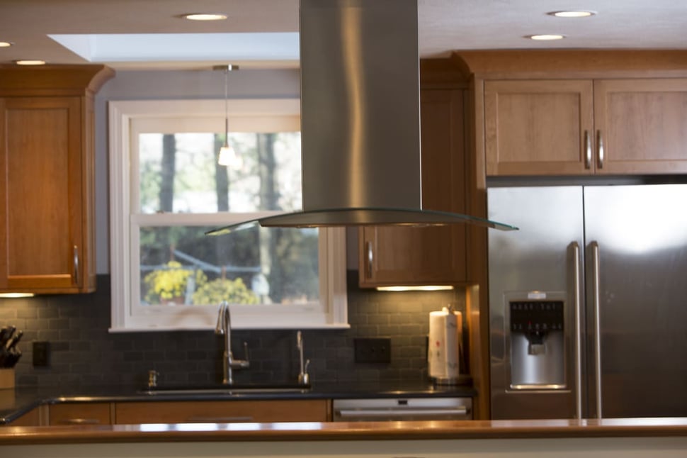 Stainless steel kitchen range hood in New Hampshire remodel by Oxland Builders