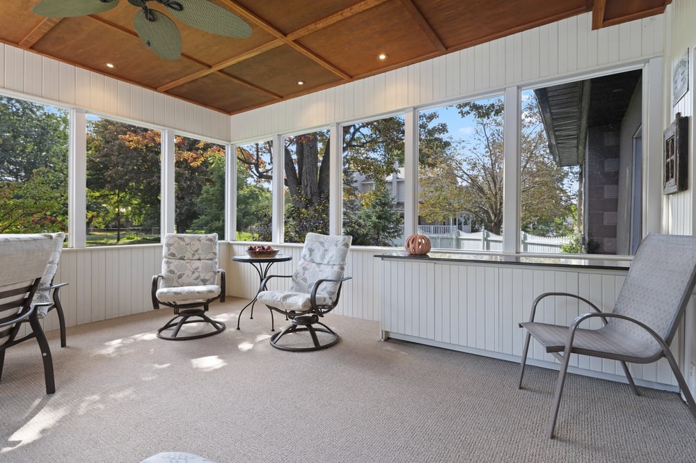 Three season room with windows and comfy chairs in home by Oxland Builders in Seacoast, NH