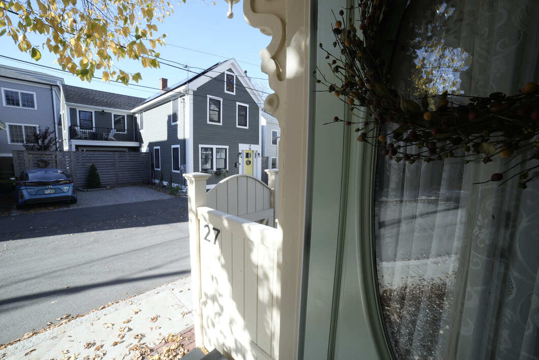 Front Area of New Hampshire Home With Green Door and New Fence on Side