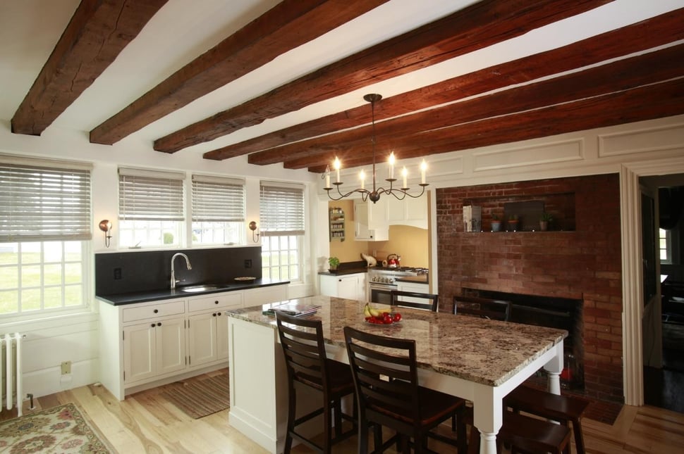 beamed ceiling kitchen island and white cabinets