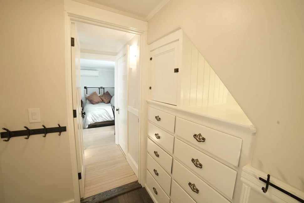 built in cabinets in hallway wall leading to bedroom in whole home remodel in new hampshire