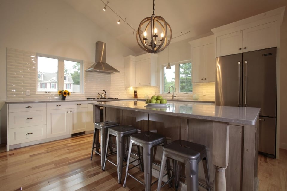 circular pendant lighting above island in New Hampshire kitchen remodel by Oxland Builders