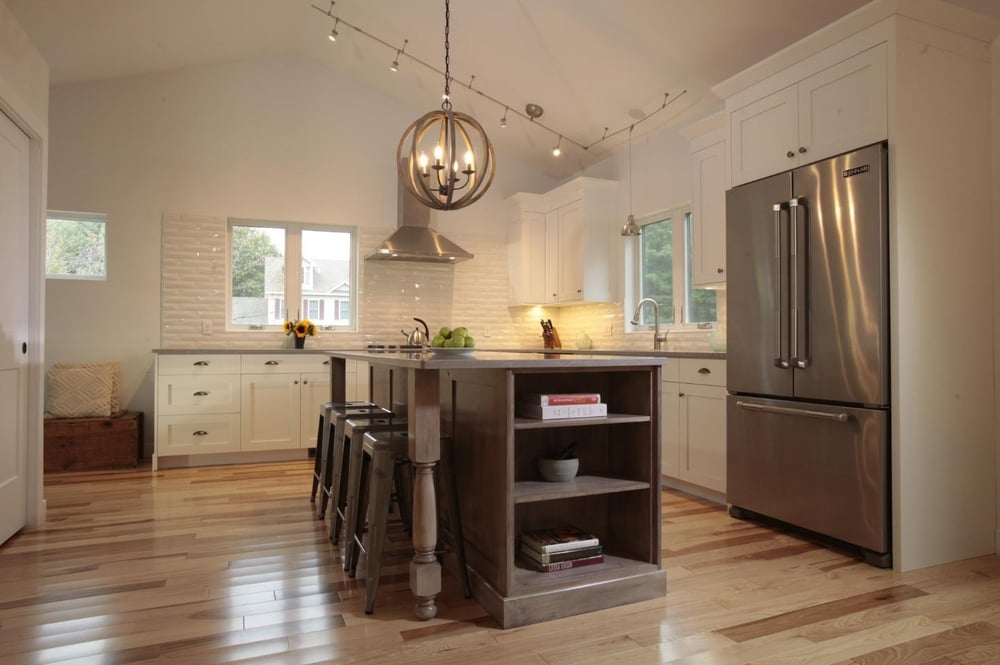 circular pendant lighting above kitchen island with built ins