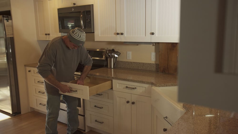 Contractor working on custom cabinetry in kitchen remodel