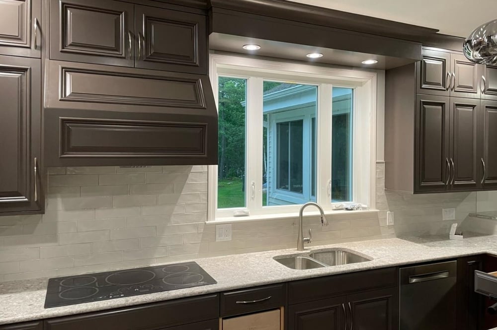 dark grey kitchen cabinets with range hood in New Hampshire kitchen renovation