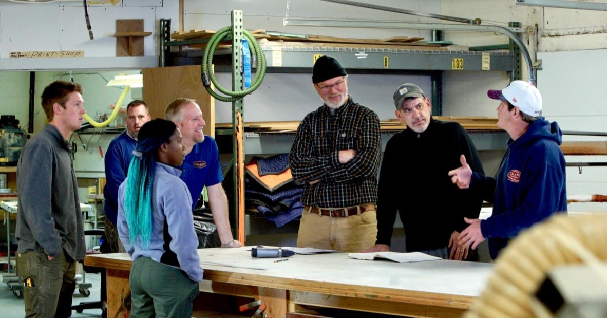 Oxland Builders team surrounding table discussing remodeling project plans