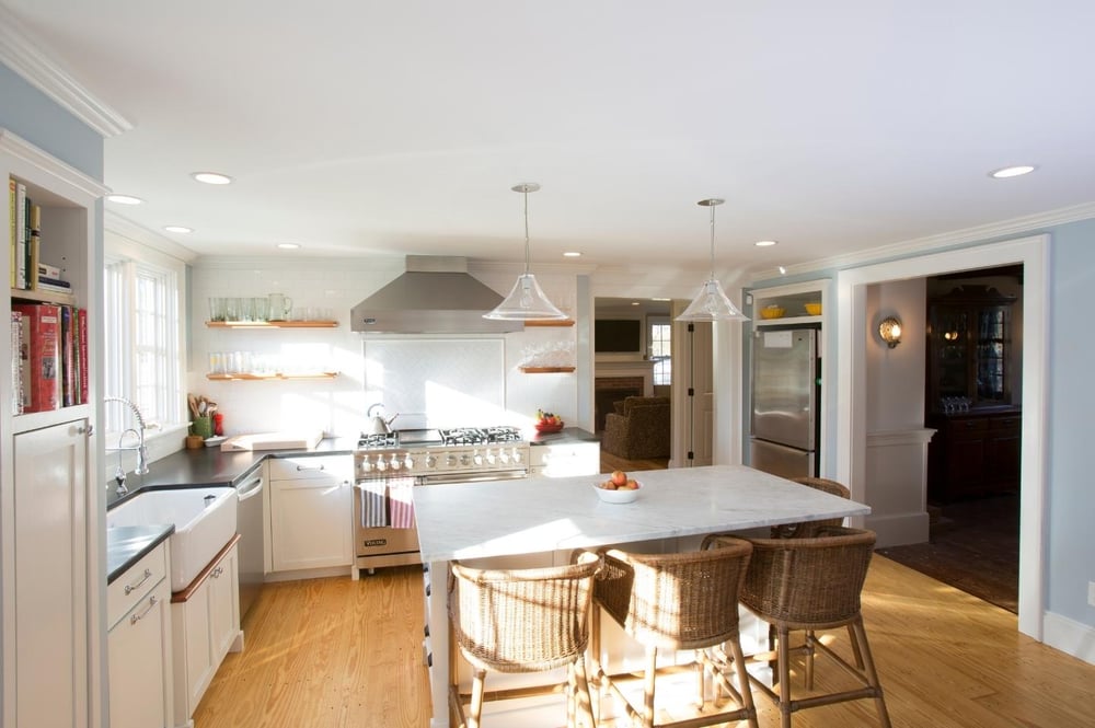 white kitchen remodel with island and stainless steel appliances