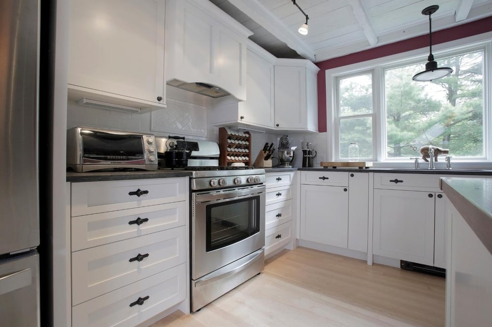 white kitchen cabinets with herringbone backsplash in New Hampshire kitchen remodel