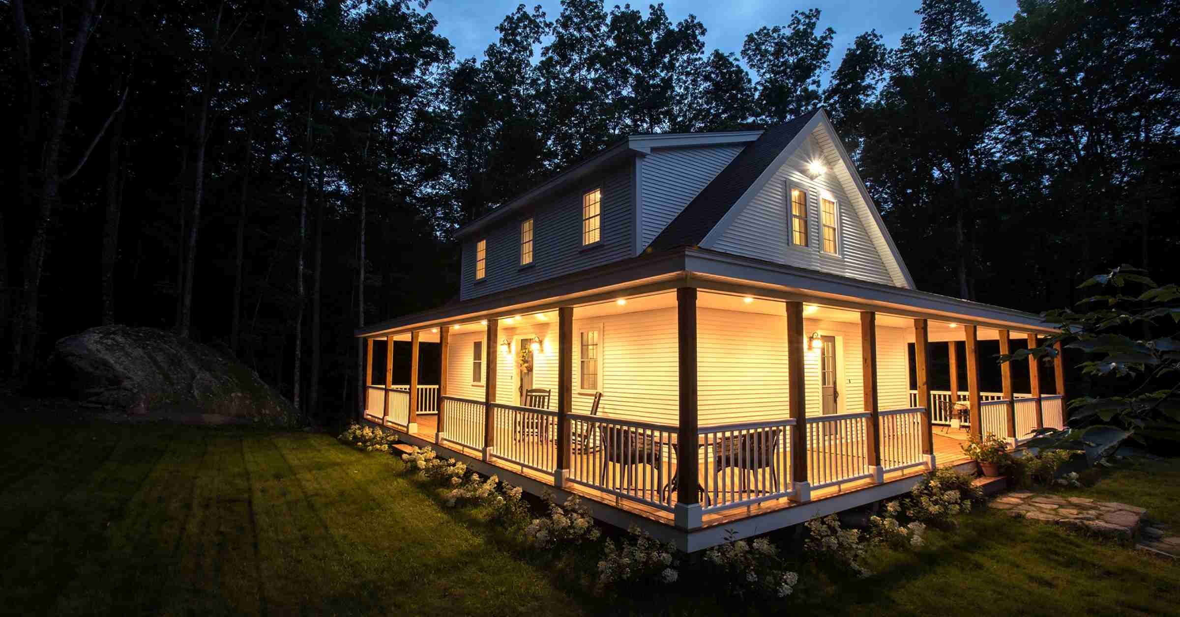 Wrap around porch with lighting on home