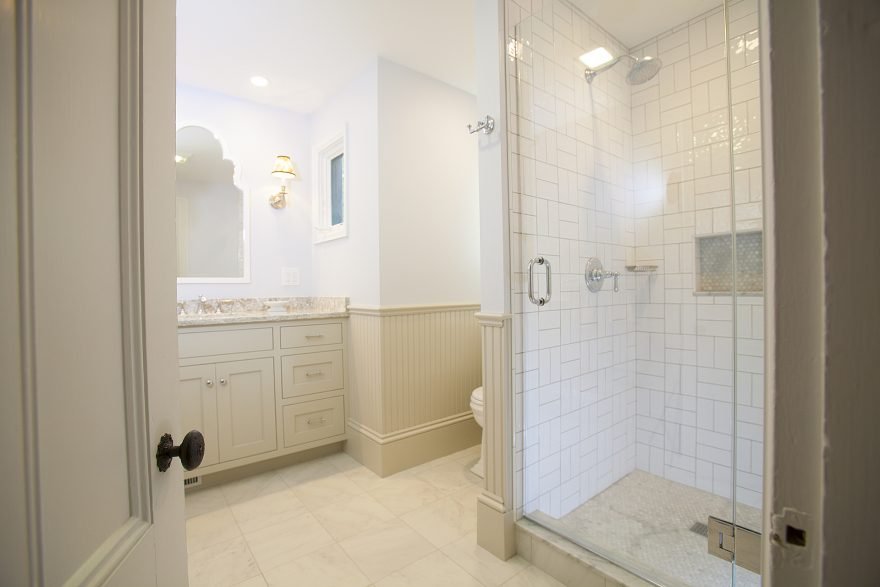 Custom Bathroom Remodel With Walk-In Shower Behind Hinged Glass Door